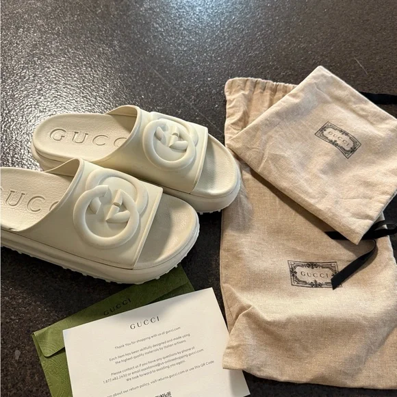 Gucci | Shoes | Gucci Ivory Embossed Logo Slides | Poshmark display picture 1